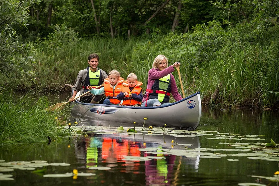 Family paddling a canoe