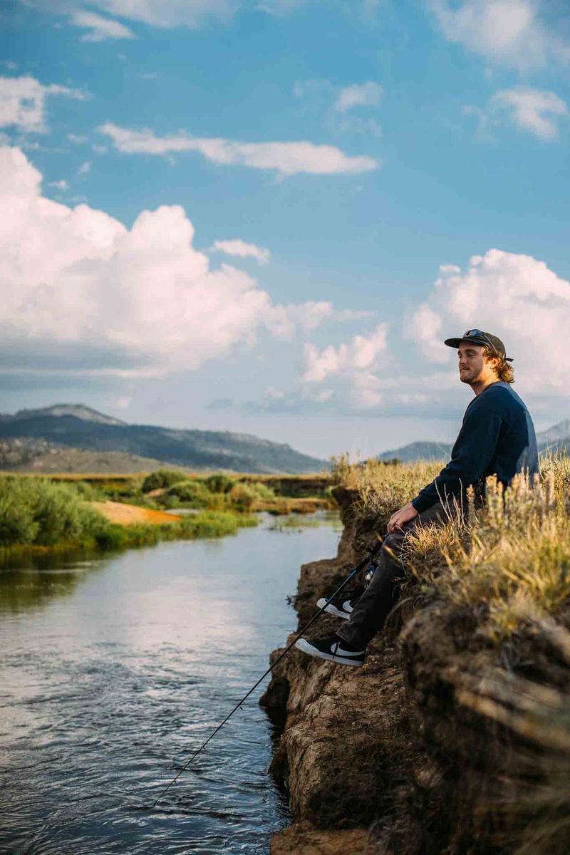 Rental owner fishing by the water while self-service bookings run on autopilot