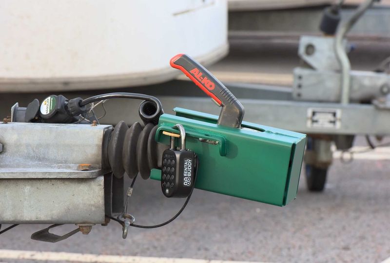 Digital padlock locking the hitch of a self-service rental trailer