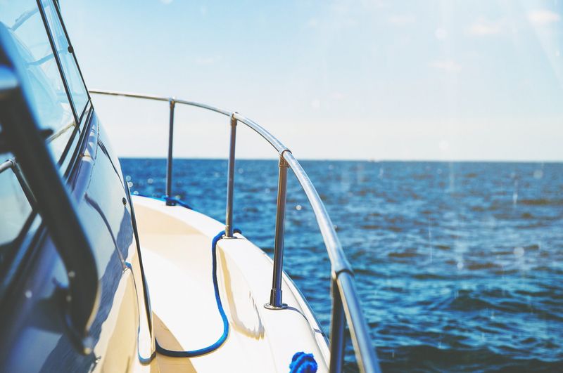 Bow of a motorboat on open blue water