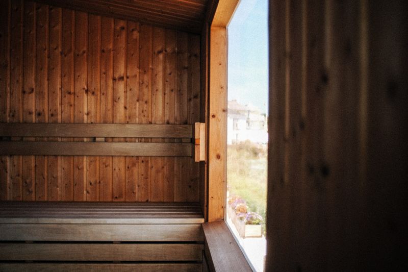 Wooden sauna interior with a window letting in natural light