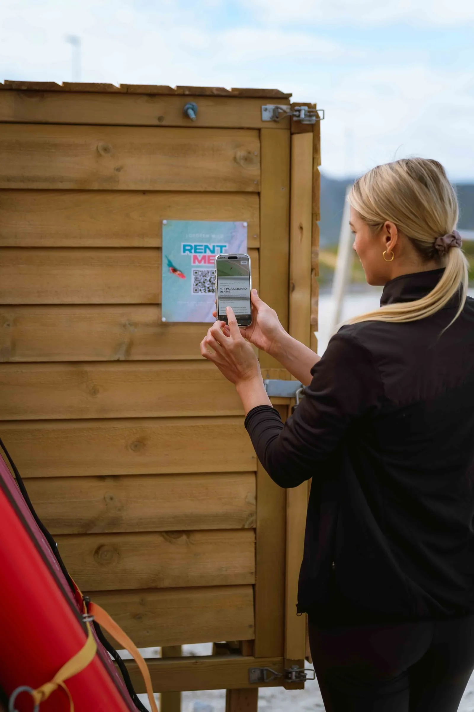 Booking a SUP via the QR code on the self-service rental cabinet at Lofoten Wild