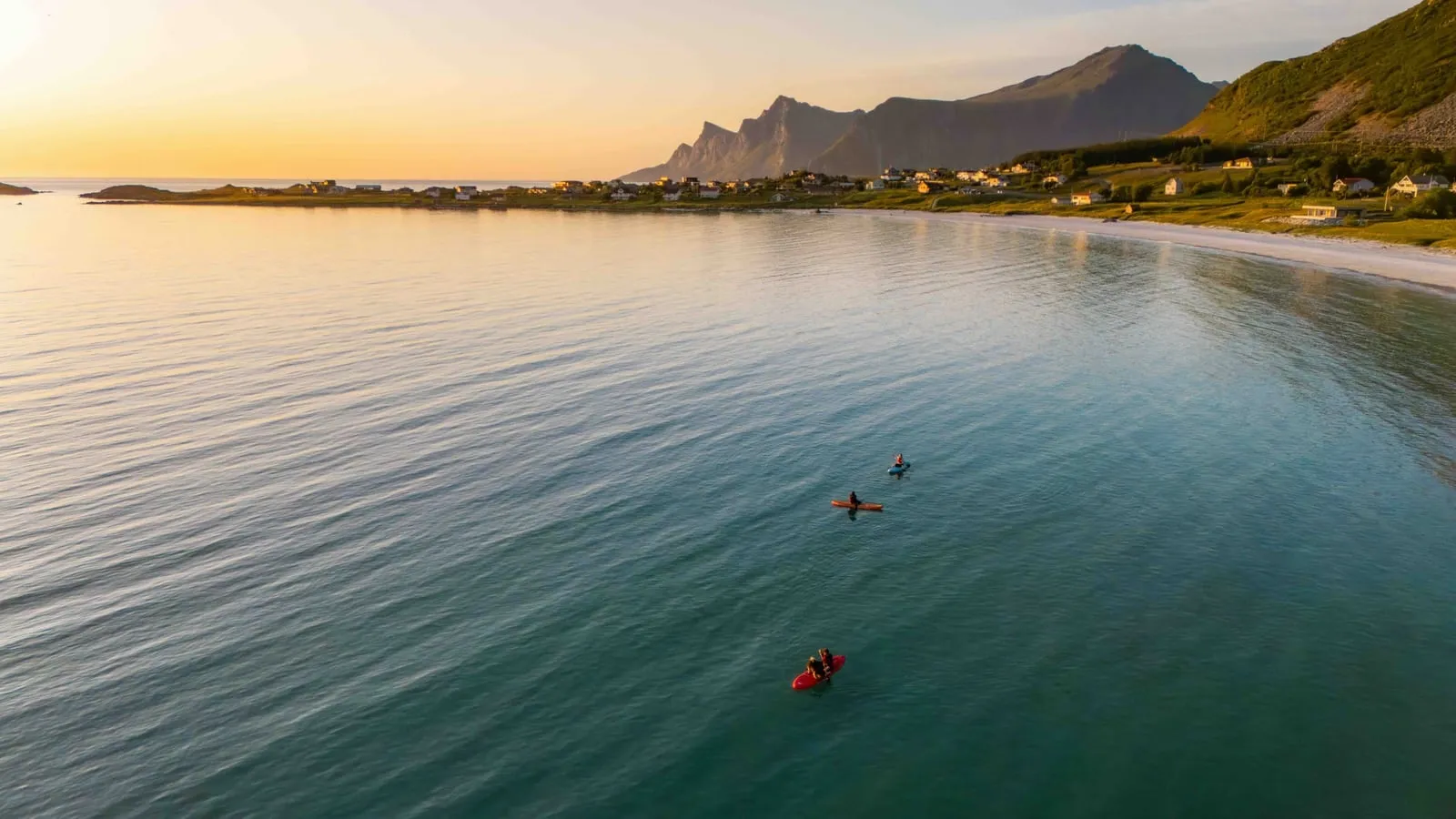 Paddler on calm open water in Lofoten, Norway