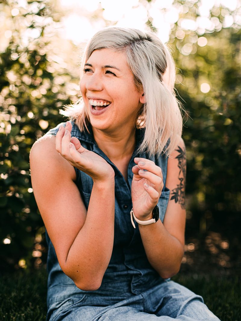 Smiling blonde woman laughing outdoors