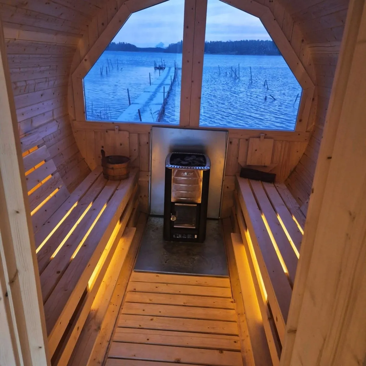 Wood-burning stove inside the self-service sauna at Strandstuviken
