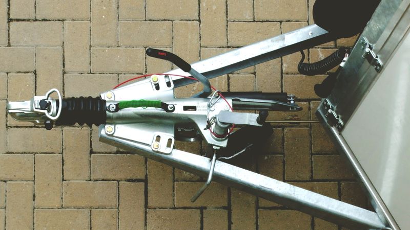 Trailer coupling and hitch on a paved driveway